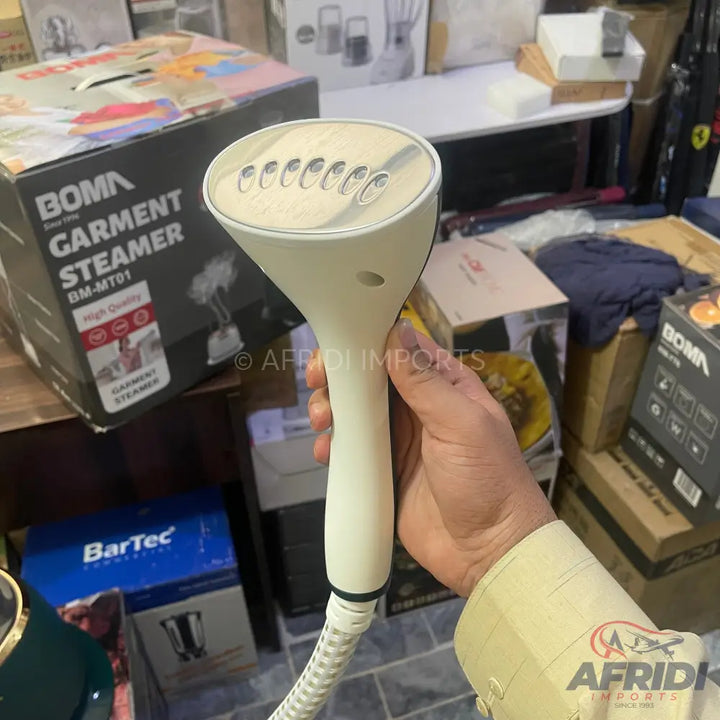 White handheld garment steamer with multiple steam vents.