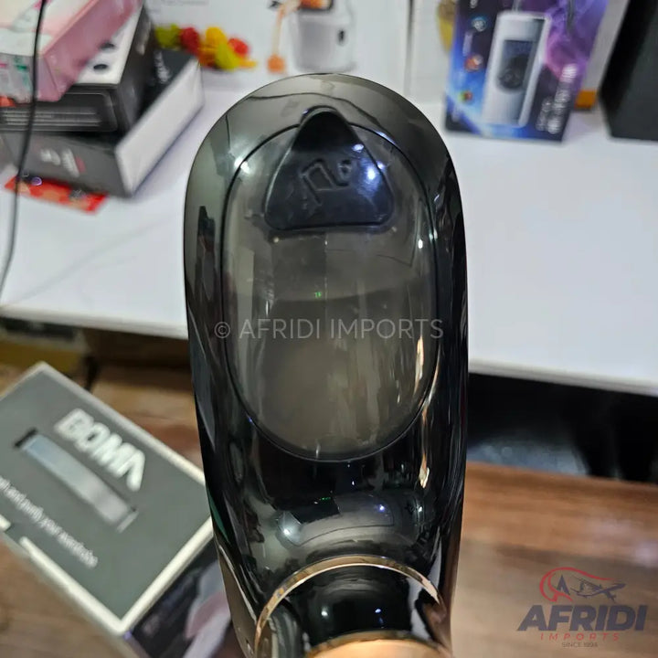 Black and transparent handheld garment steamer with a gold-colored base.