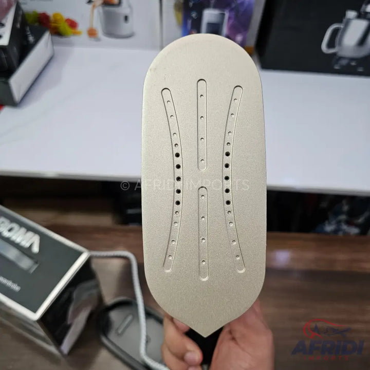 A handheld garment steamer with a gold-colored soleplate and steam vents.