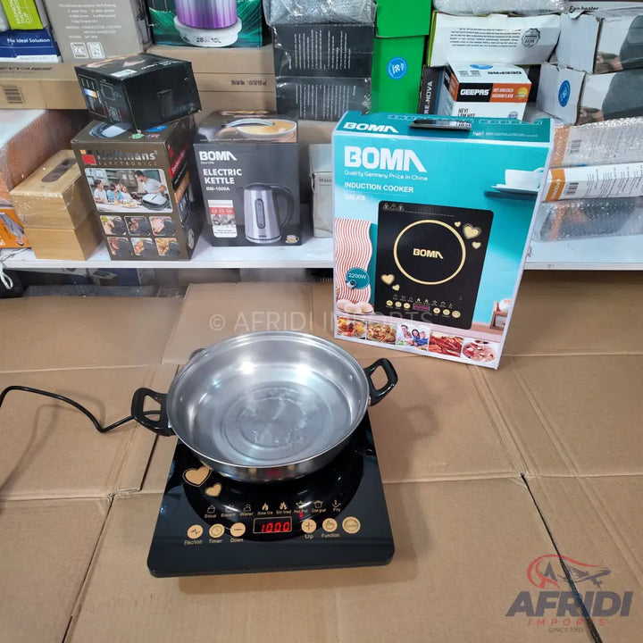 Black induction cooker with a silver pot of water.