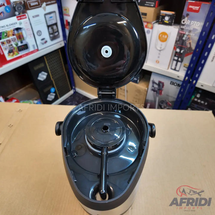 Black and silver thermal airpot with an open lid, revealing the pump mechanism.