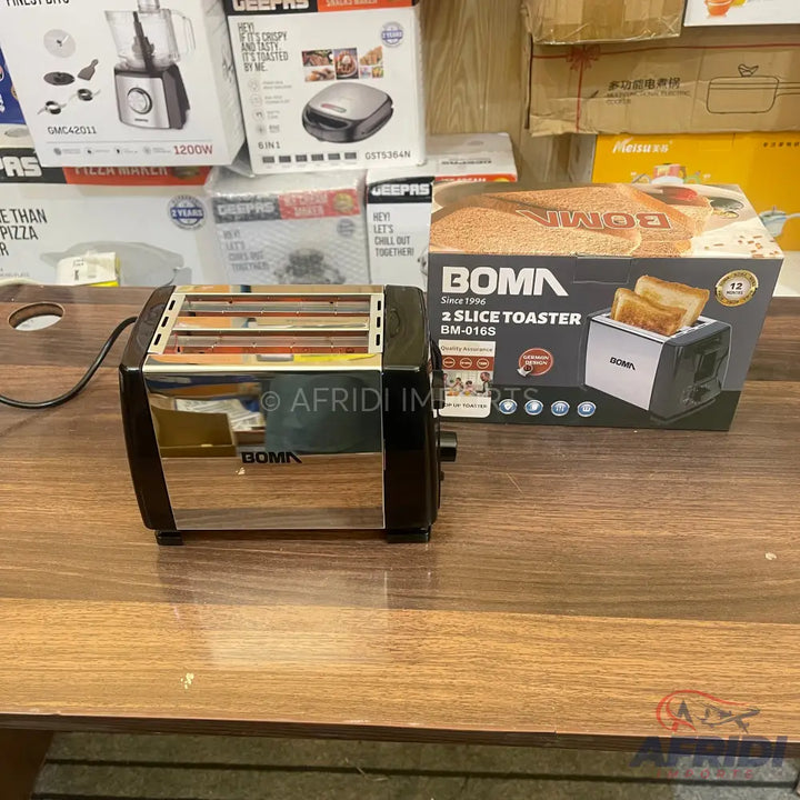 A shiny black and silver two-slice toaster with a power cord, accompanied by its packaging box featuring an image of the toaster and toasted bread.