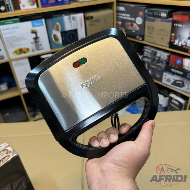 A stainless steel and black sandwich maker with indicator lights.