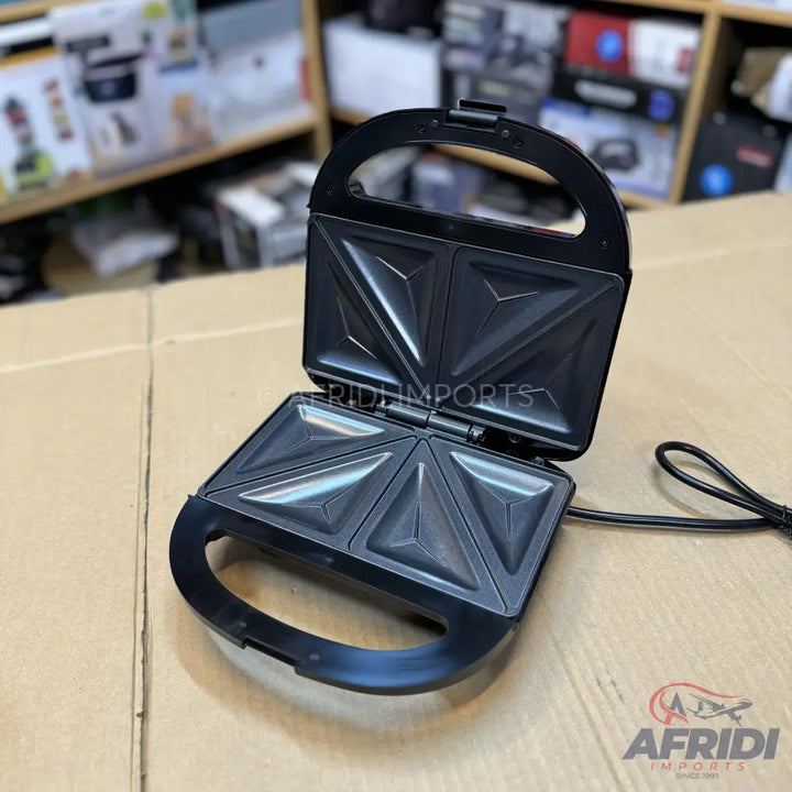 Open black sandwich maker with triangular cooking plates.