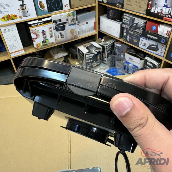 Black electric sandwich maker with a hinged lid.