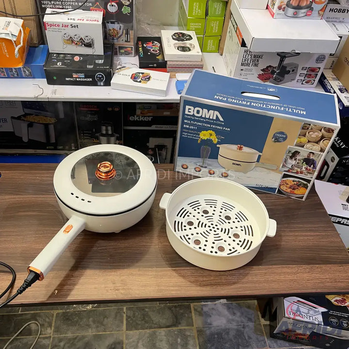 White multifunction electric frying pan with a glass lid and a separate steamer insert.