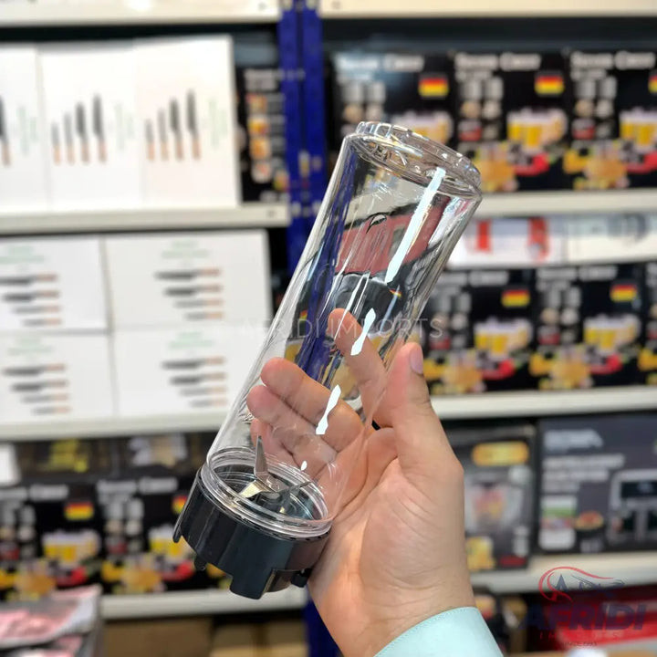 A clear plastic blender cup with a black base and integrated blades.