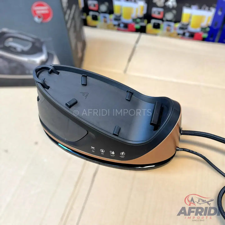 A black and copper-colored cordless steam iron base with indicator lights.