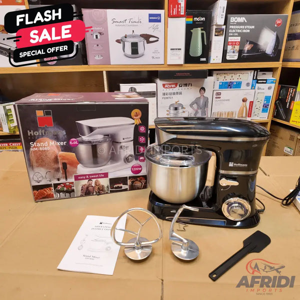 Black stand mixer with a stainless steel bowl and various attachments.
