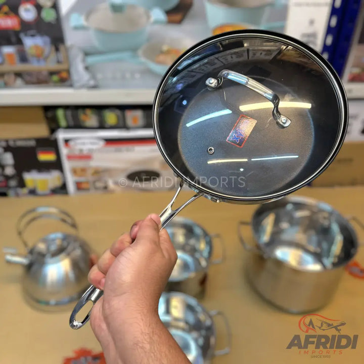 Stainless steel saucepan with a clear glass lid and a long handle.