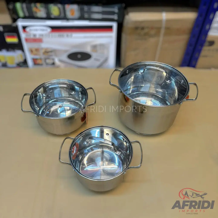 Set of three shiny stainless steel cooking pots with side handles.