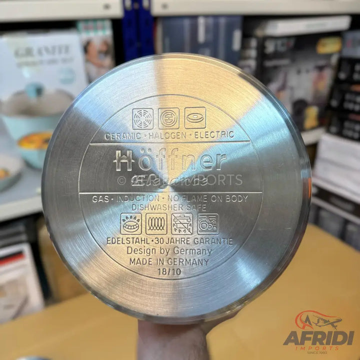 The bottom of a stainless steel cooking pot, compatible with various heat sources, designed in Germany.