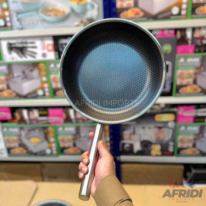 A black non-stick frying pan with a honeycomb pattern and a silver handle.
