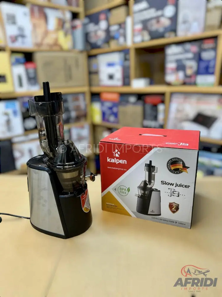 A silver and black slow juicer with a clear top chamber, shown next to its product box.