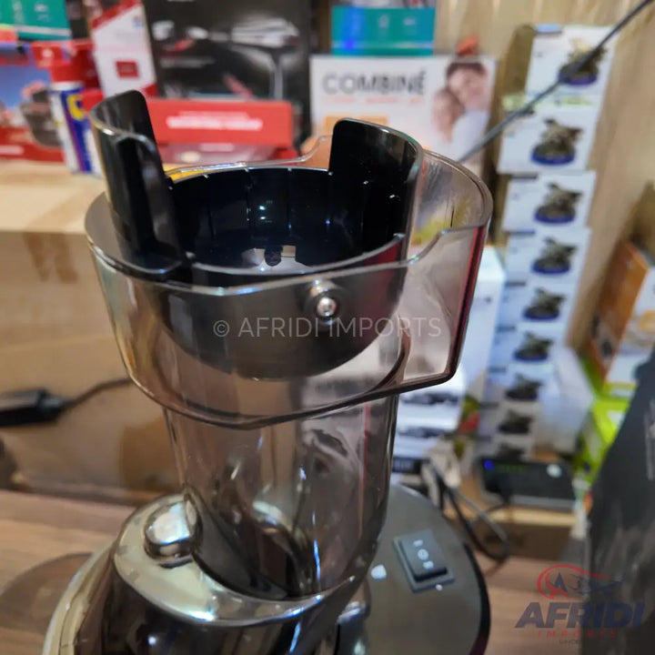 A black and silver electric coffee grinder with a clear hopper and a toggle switch.