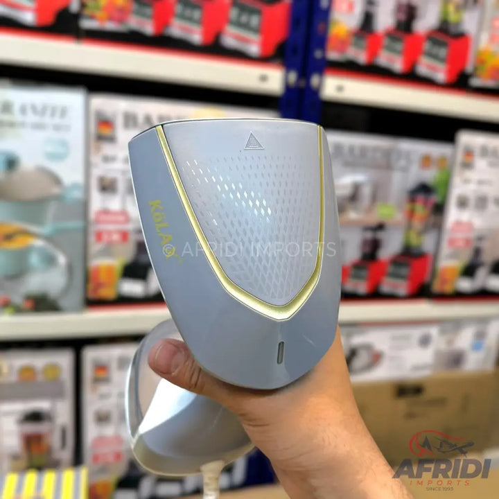 Gray and gold handheld garment steamer with a textured surface.
