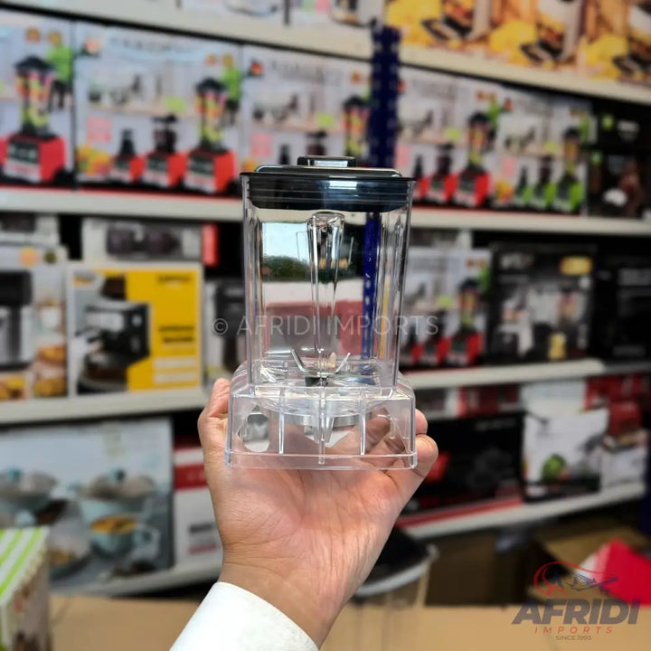 Clear plastic blender cup with a black lid and an attached blade assembly.