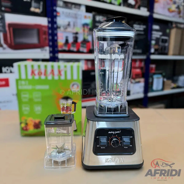 A stainless steel blender with a large clear pitcher and a smaller personal blending cup.
