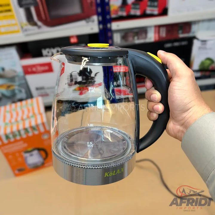 A clear glass electric kettle with a black handle and a silver base.
