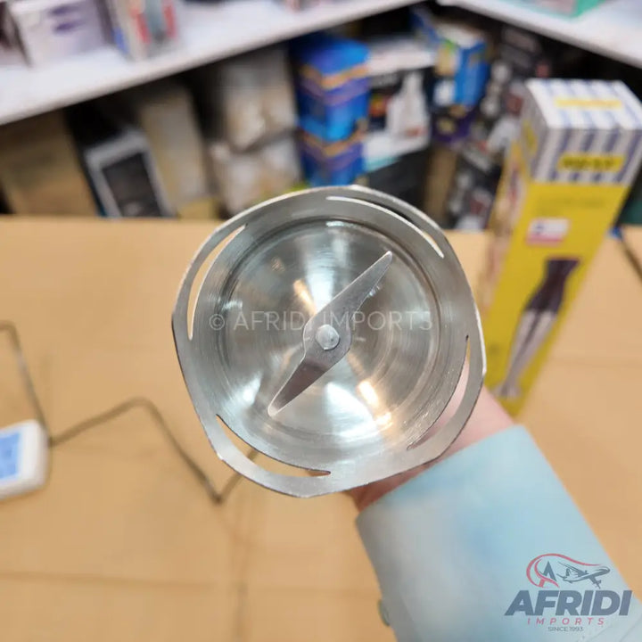 Stainless steel immersion blender head with exposed sharp blades.