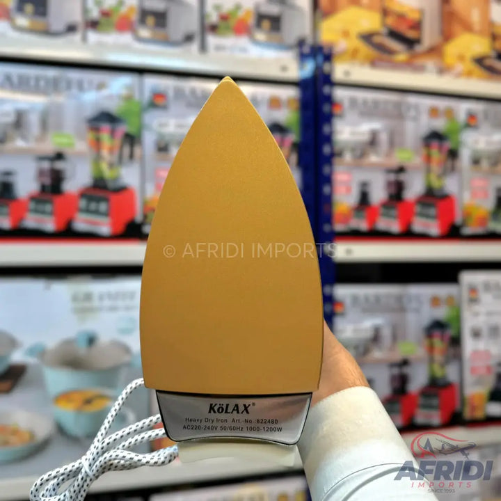 A yellow dry iron with a silver base.