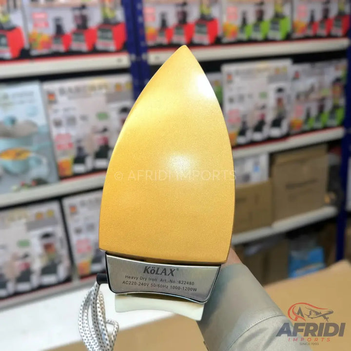A yellow-gold, heavy-duty dry iron with a silver base.