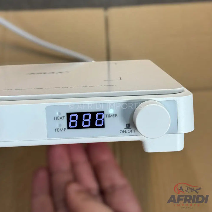 White rectangular kitchen appliance with a digital display, heat/temp and timer indicators, and a control knob.