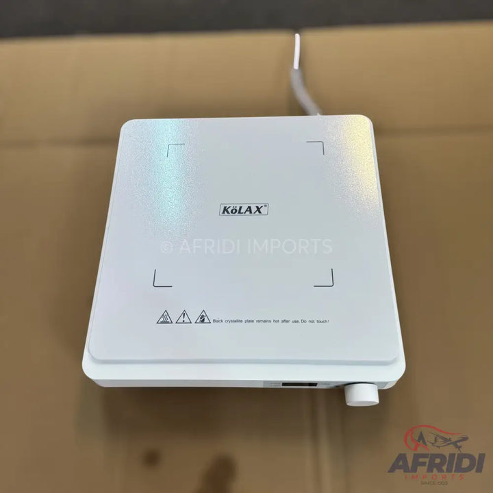 White, square, portable induction cooktop with a single burner area.