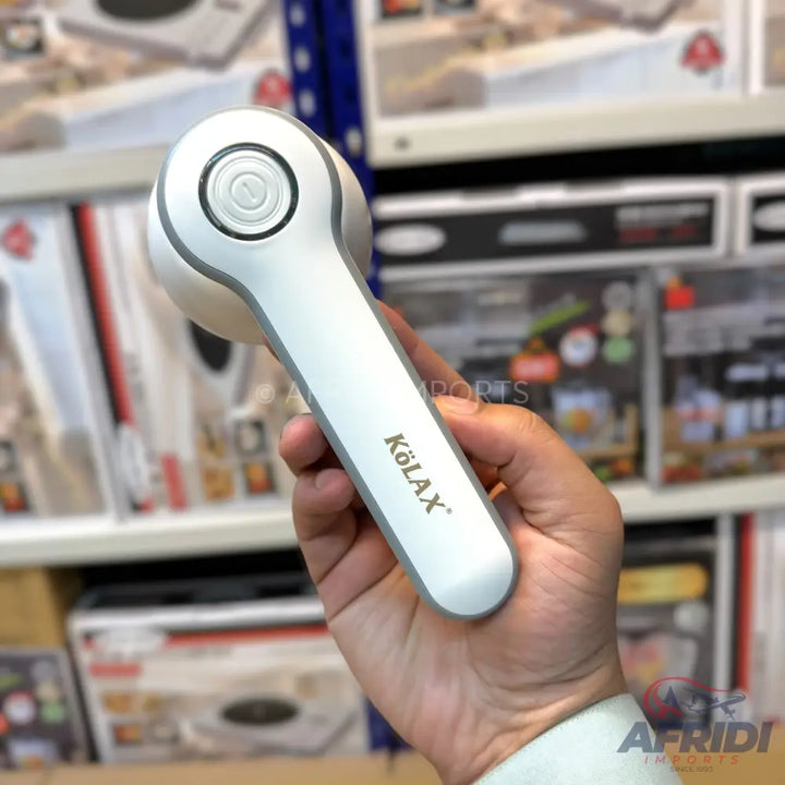 A white and grey handheld lint remover with an ergonomic design.