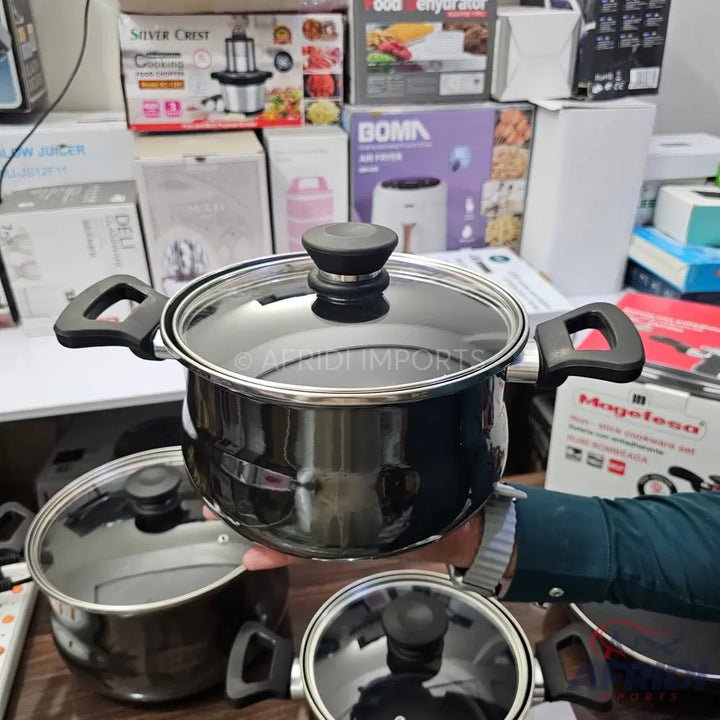 Black metal cooking pot with a glass lid and black handles