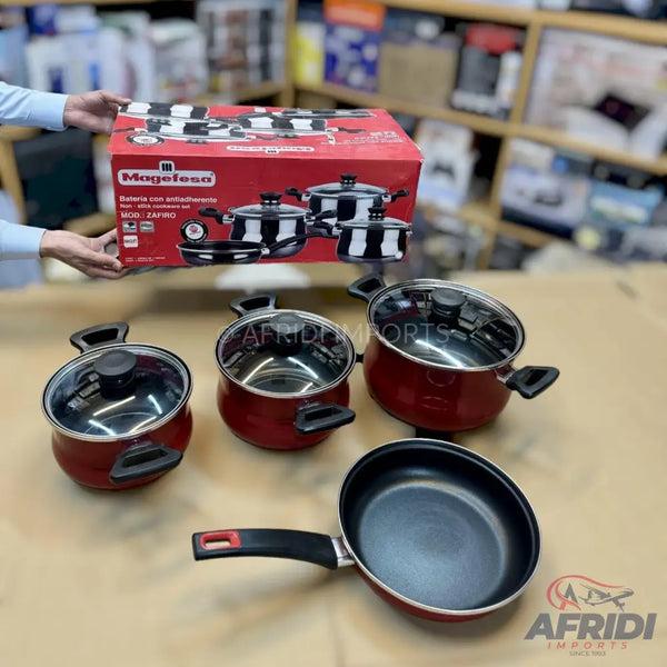A set of red and black cookware including pots with lids and a frying pan.