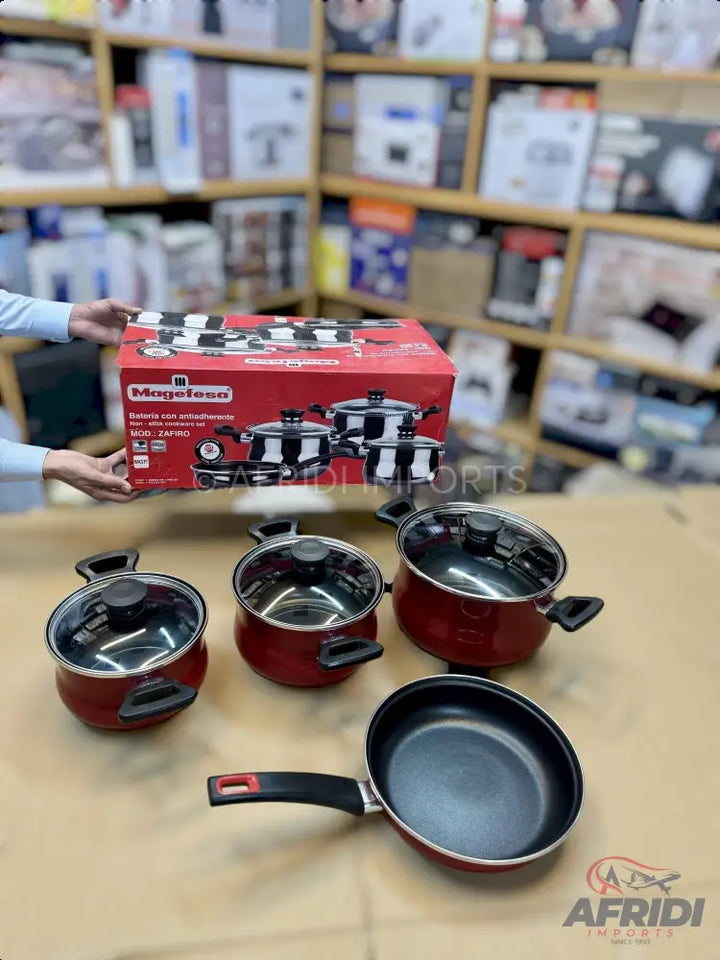A red and black cookware set including pots with lids and a frying pan.