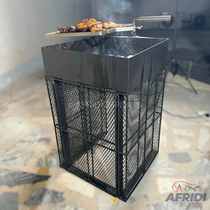 A black metal grill with a top tray of cooking chicken.