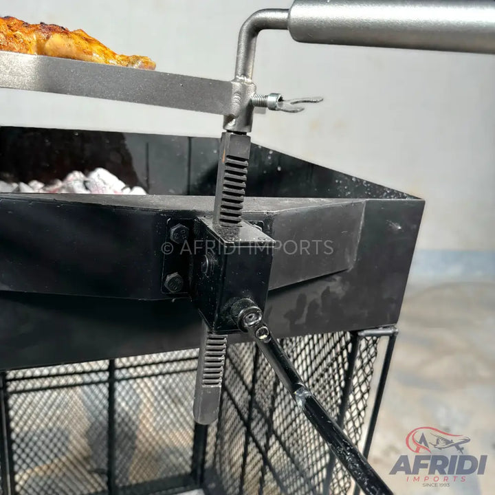 A height-adjustable charcoal grill with a rotisserie attachment.