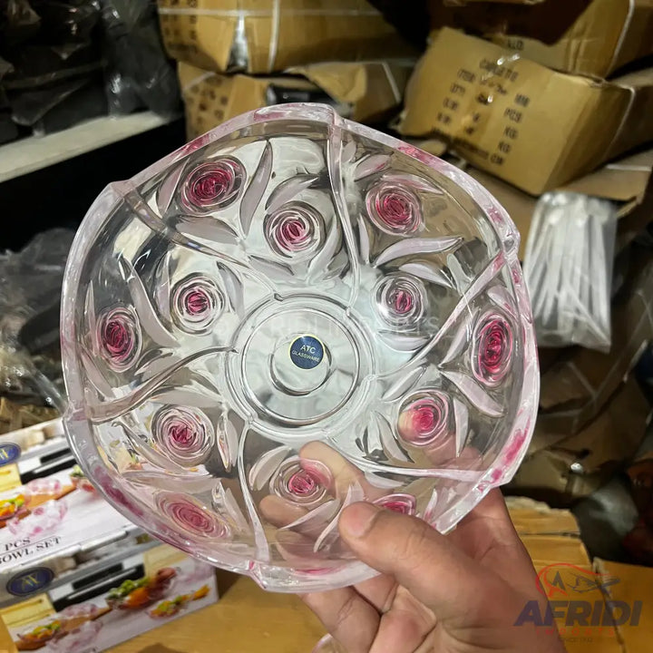 Clear glass decorative bowl with raised pink rose designs.