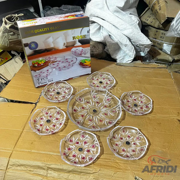 A 7-piece glass plate set with a decorative floral design.