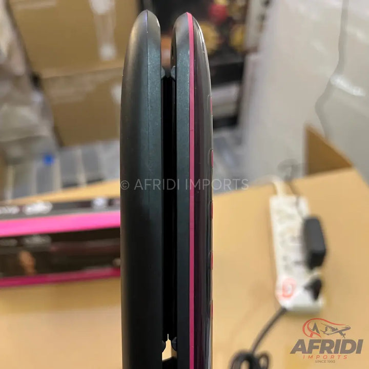 Black hair straightener with pink accents.
