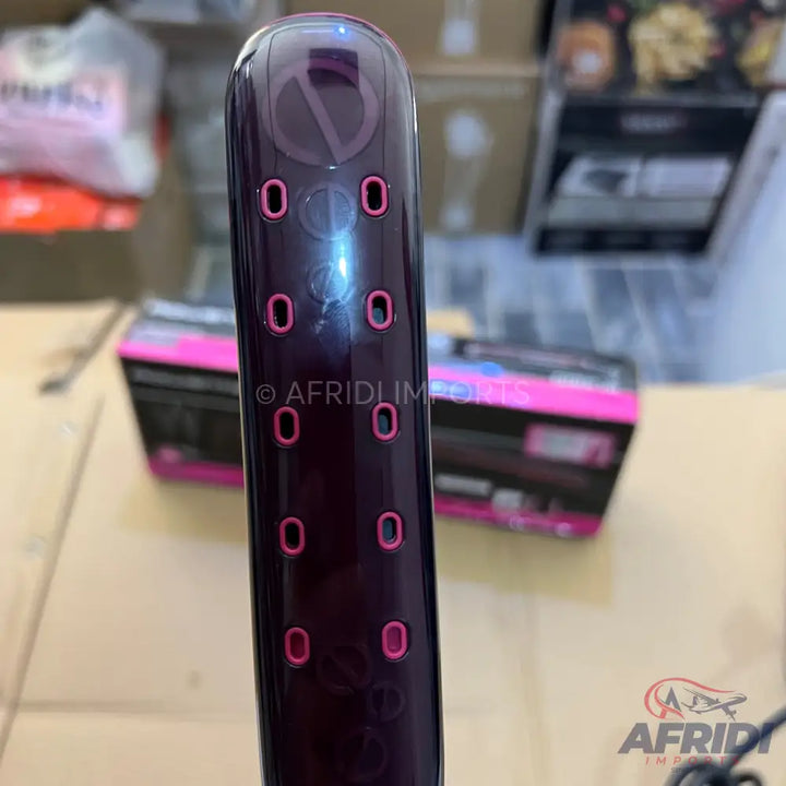 Purple hair curler with pink heat settings.
