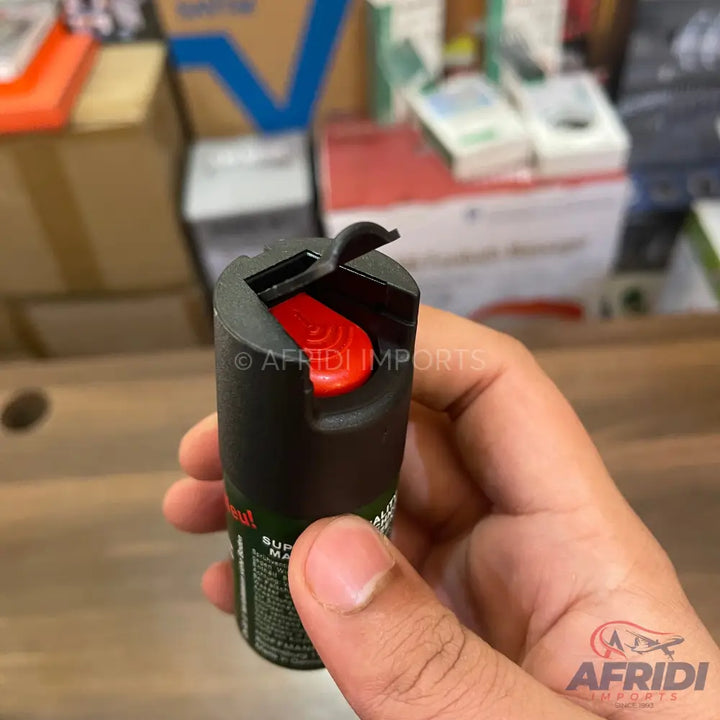 Black pepper spray with a red trigger.