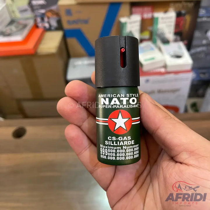 A dark green pepper spray canister with a black top.