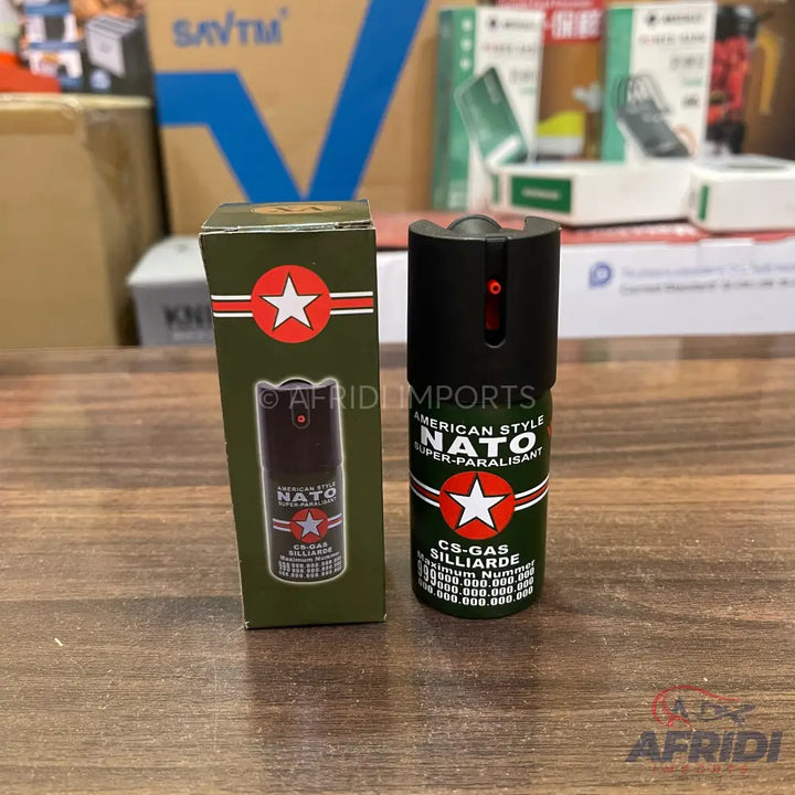 A black and olive green pepper spray canister with a red star emblem.