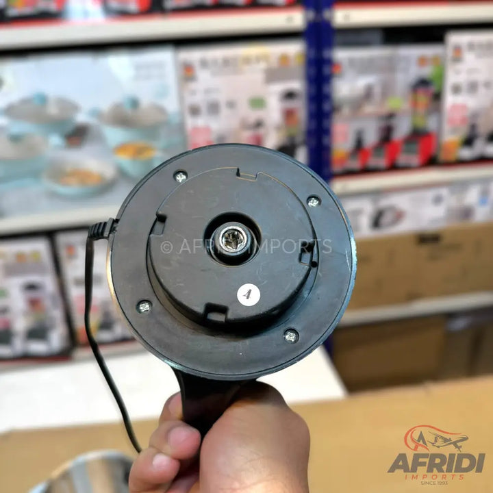 The underside of a black electric kettle with a power connector.