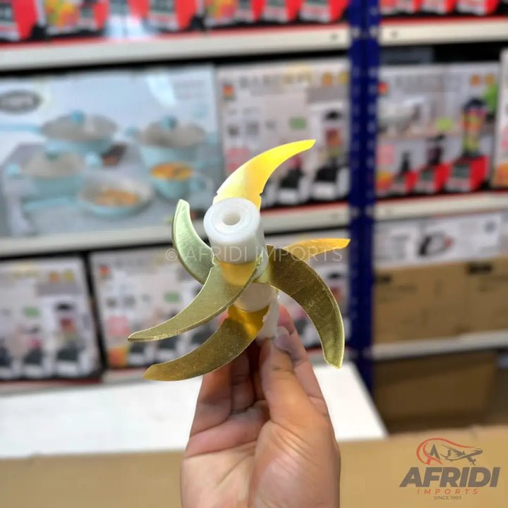 A gold-colored, six-blade food chopper attachment.