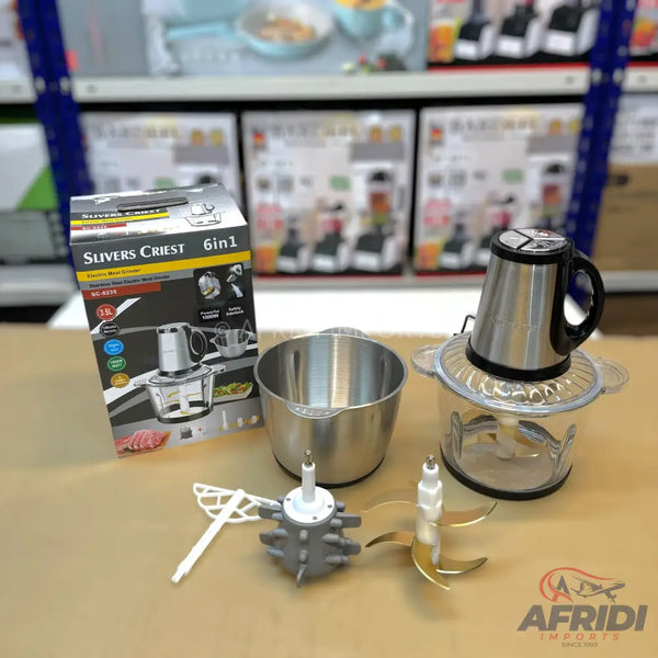 A stainless steel and clear plastic food processor with multiple attachments.
