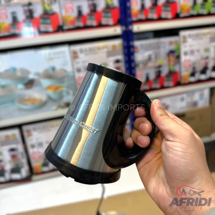 Stainless steel electric beverage mug with a black handle and base.