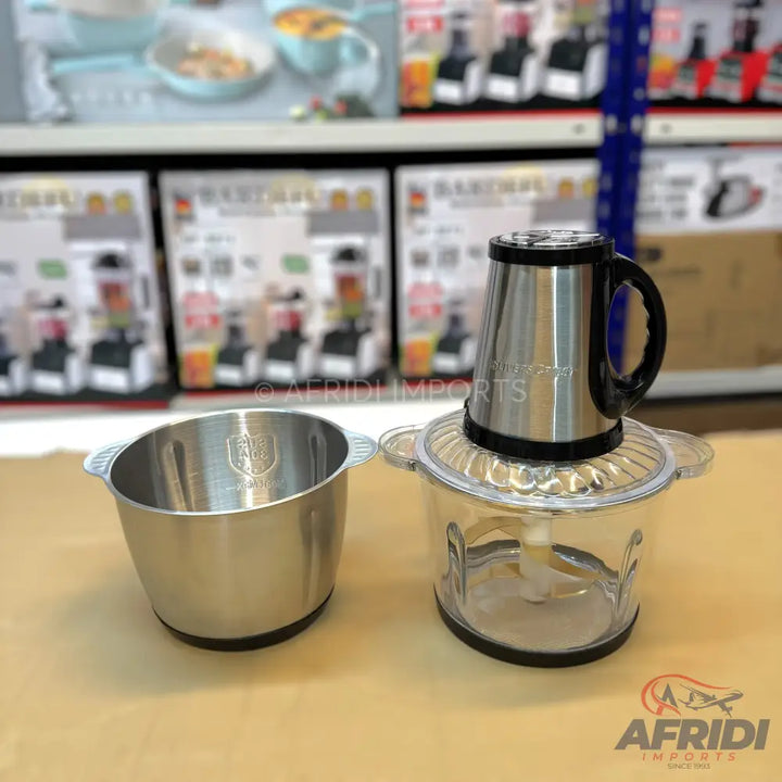 Two-bowl electric food chopper with stainless steel and glass bowls.