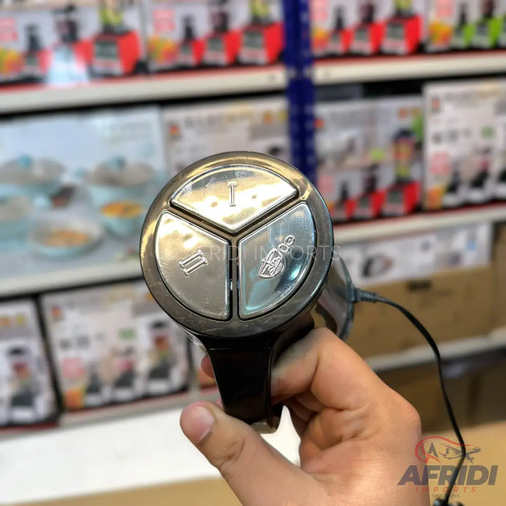 Handheld immersion blender with three-button control panel.