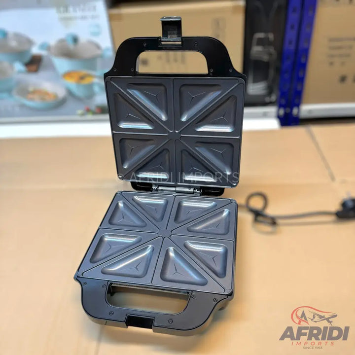 Open black electric sandwich maker with non-stick triangular grill plates.