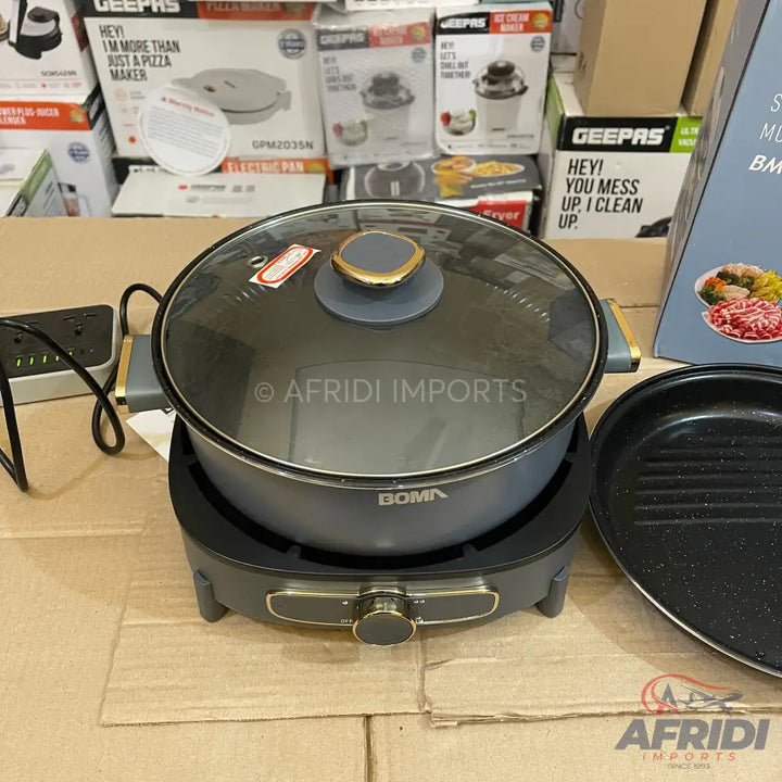 A multi-functional electric cooking pot with a glass lid and an additional grill plate.