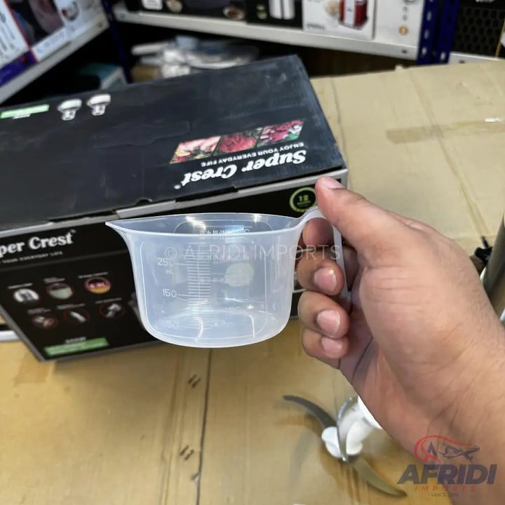 A clear plastic measuring cup with a handle.
